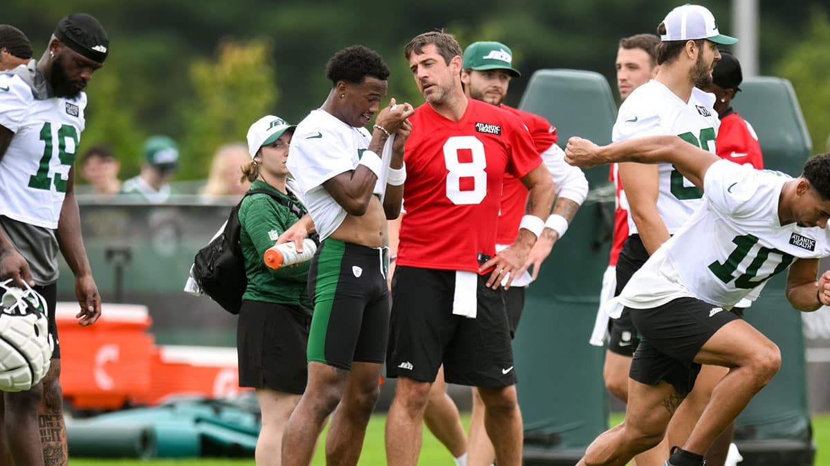 New York Jets quarterback Aaron Rodgers (8) talks with wide receiver Garrett Wilson (5) during training camp at Atlantic Health Jets Training Center.
