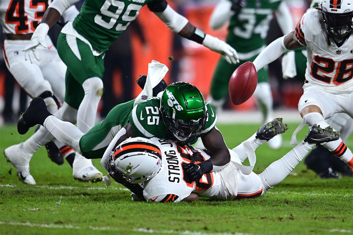 New York Jets running back Israel Abanikanda (25) fumbles a punt return during the first half against the Cleveland Browns at Cleveland Browns Stadium. 