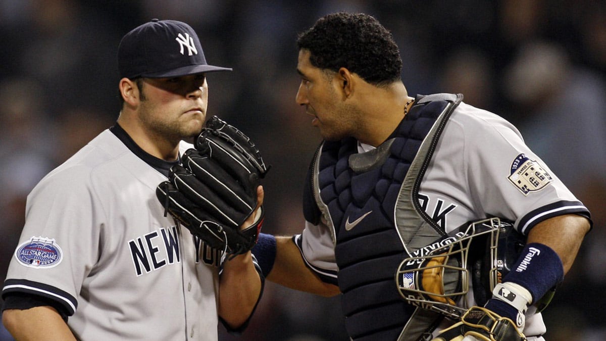 New York Yankees catcher Jose Molina (right) talks with relief pitcher Joba Chamberlain during the ninth inning against the Chicago White Sox at US Cellular Field. The White Sox beat the Yankees 7-6.