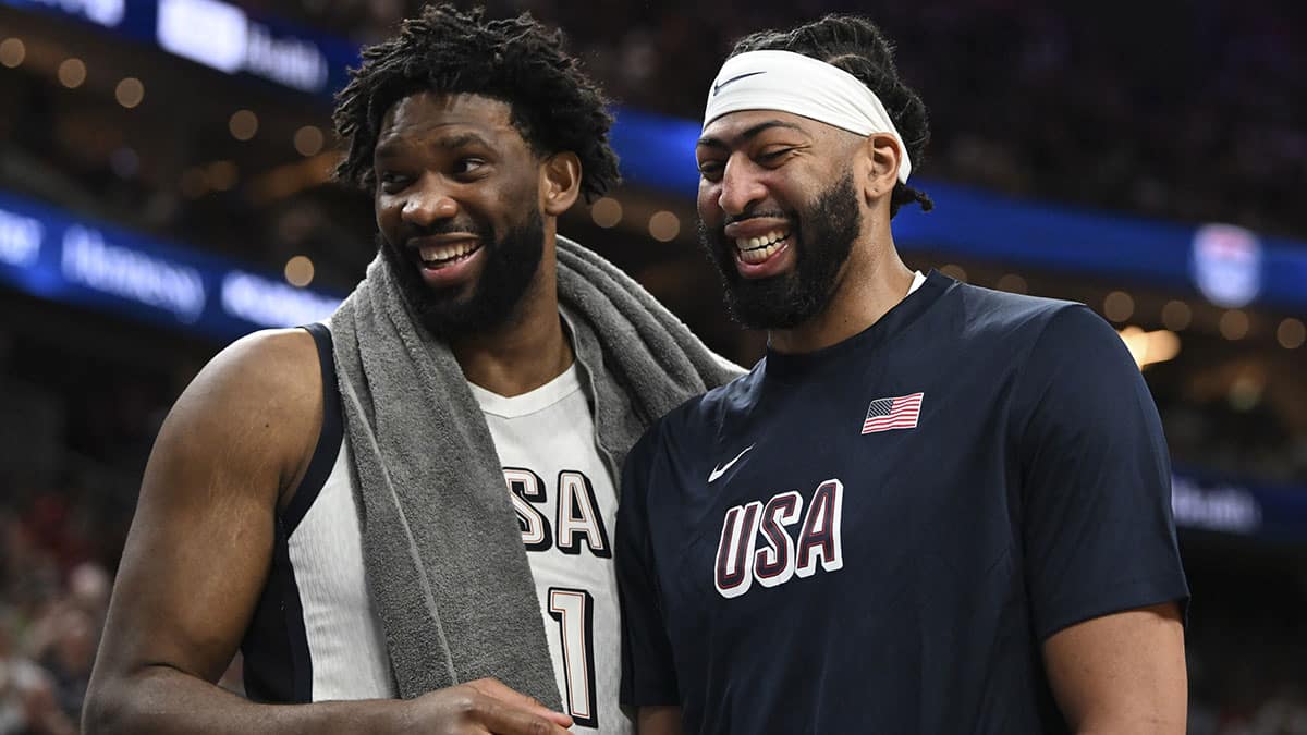 USA forward Joel Embiid (11) and forward Anthony Davis (14) laugh together on the bench during the fourth quarter against Canada in the USA Basketball Showcase at T-Mobile Arena.