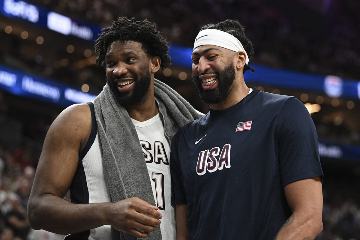 USA forward Joel Embiid (11) and forward Anthony Davis (14) laugh together on the bench during the fourth quarter against Canada in the USA Basketball Showcase at T-Mobile Arena. 