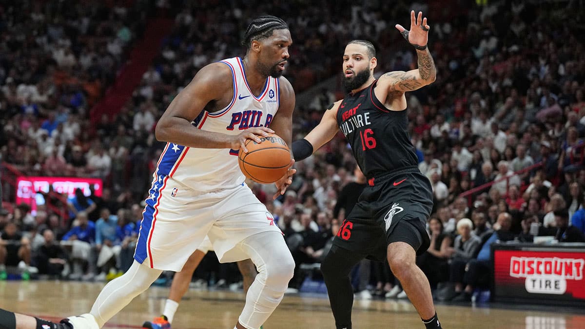 Philadelphia 76ers center Joel Embiid (21) drives past Miami Heat forward Caleb Martin (16) during the second half at Kaseya Center.