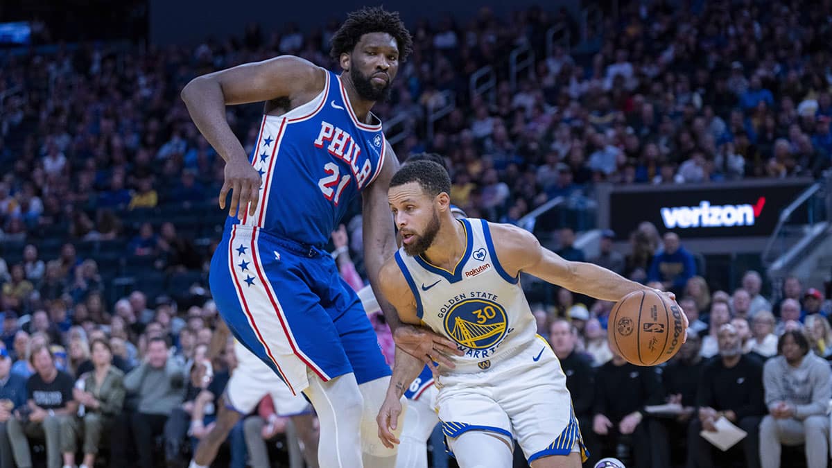  Golden State Warriors guard Stephen Curry (30) drives against Philadelphia 76ers center Joel Embiid (21) during the fourth quarter at Chase Center. 