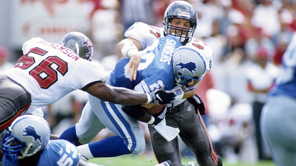 Oct 12, 1997; Tampa, FL; USA; FILE PHOTO; Tampa Bay safety John Lynch (47) tackles Detroit Lions running back Barry Sanders (20) during the 1997 season at Tampa Stadium