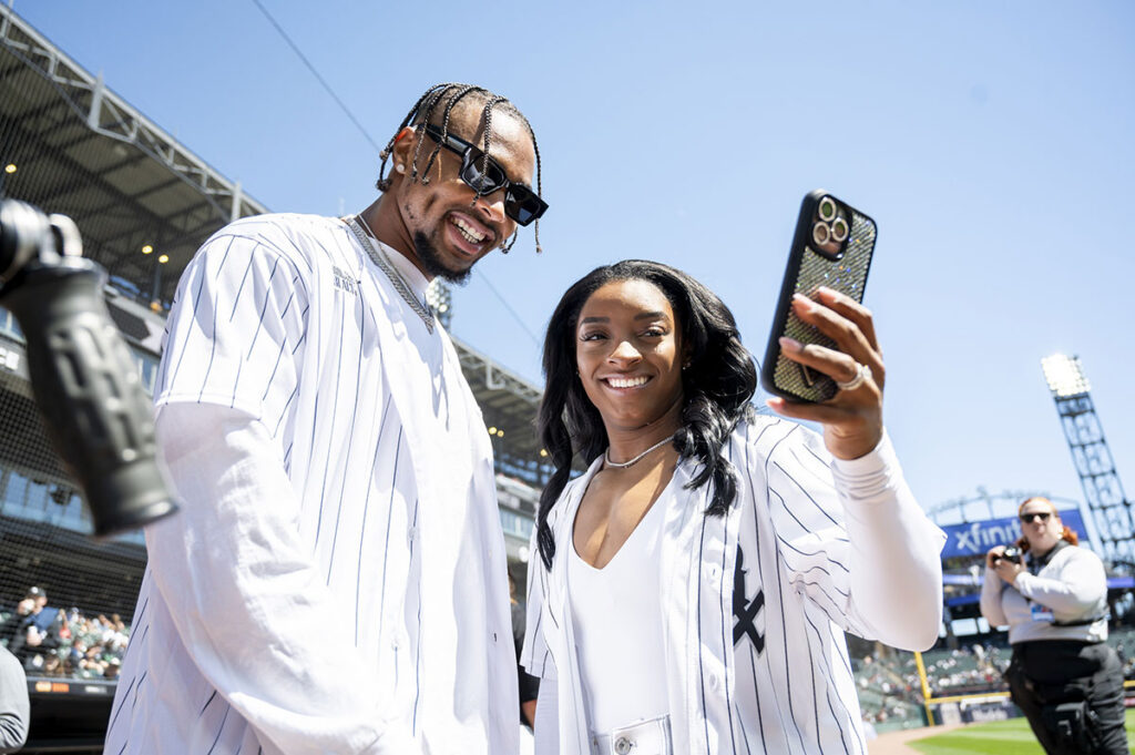 Chicago Bears safety Jonathan Owens and American gymnast Simone Biles take a selfie prior to a game between the Chicago White Sox and the Cincinnati Reds at Guaranteed Rate Field.