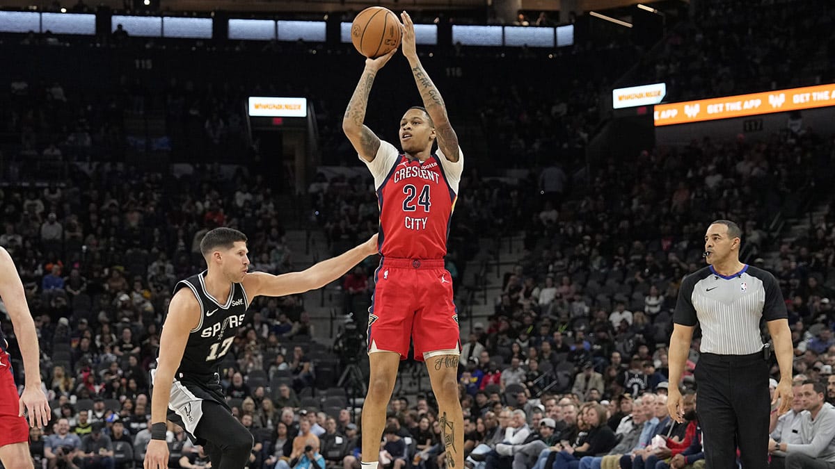 New Orleans Pelicans guard Jordan Hawkins (24) shoots over San Antonio Spurs forward Doug McDermott (17) during the first half at Frost Bank Center.