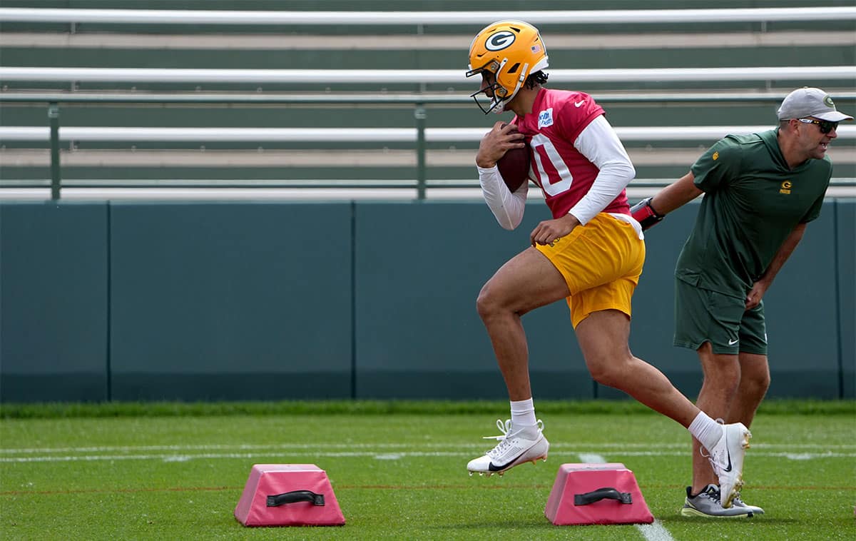 Green Bay Packers quarterback Jordan Love (10) is carries a ball at minicamp.