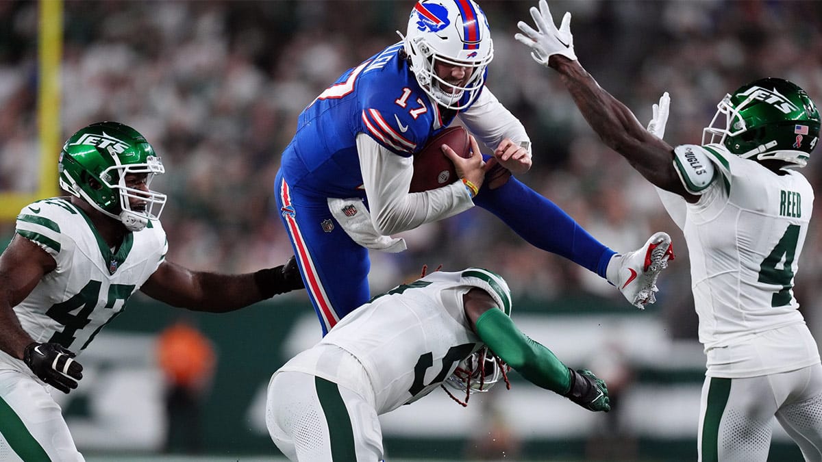 Buffalo Bills quarterback Josh Allen hurdles New York Jets linebacker C.J. Mosley during the first half at MetLife Stadium.