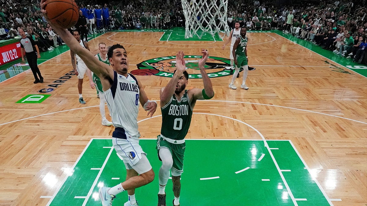 Dallas Mavericks guard Josh Green (8) shoots the ball against Boston Celtics forward Jayson Tatum (0) in game five of the 2024 NBA Finals at TD Garden.