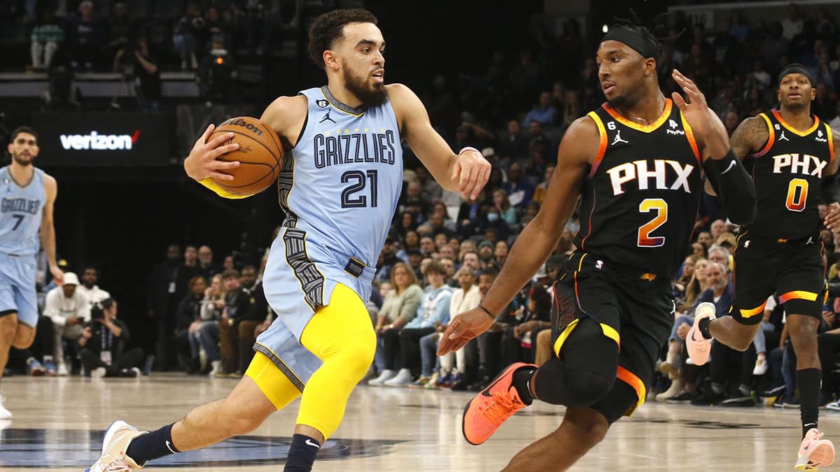 Memphis Grizzlies guard Tyus Jones (21) drives to the basket as Phoenix Suns forward Josh Okogie (2) defends during the first half at FedExForum.