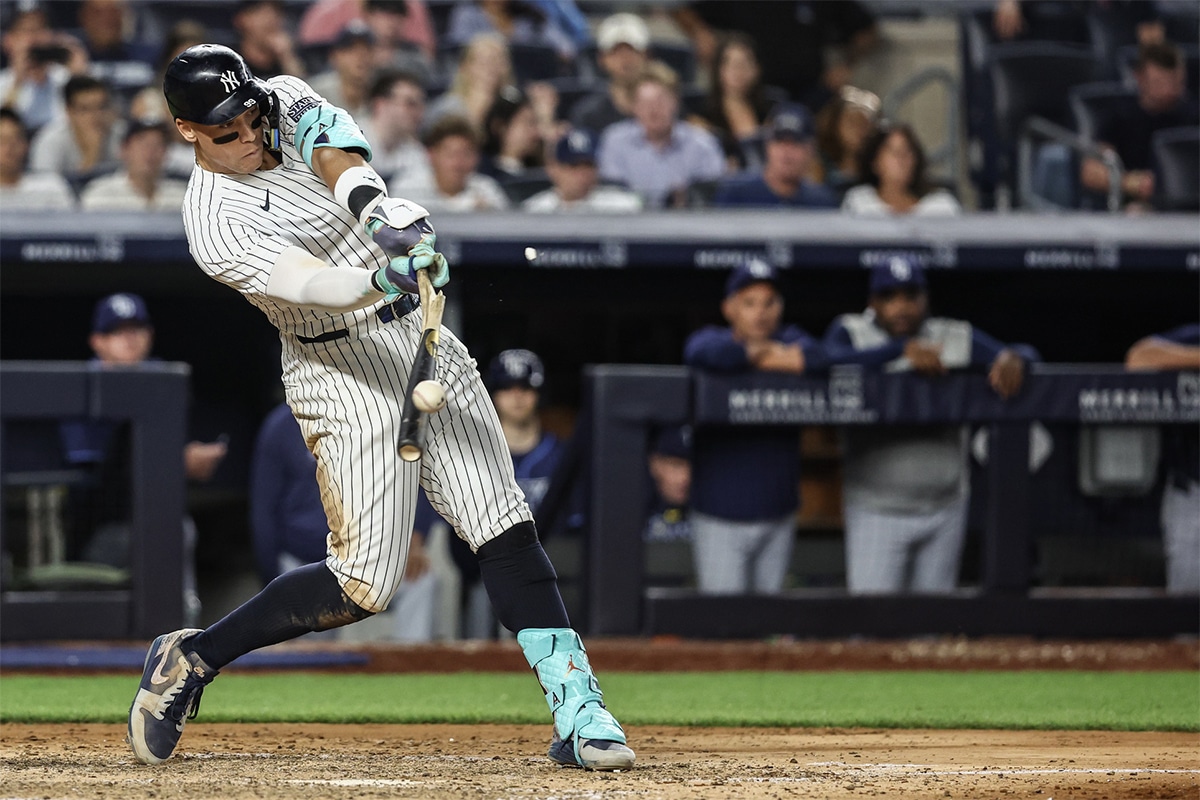 New York Yankees designated hitter Aaron Judge (99) hits an RBI single in the sixth inning against the Tampa Bay Rays at Yankee Stadium.