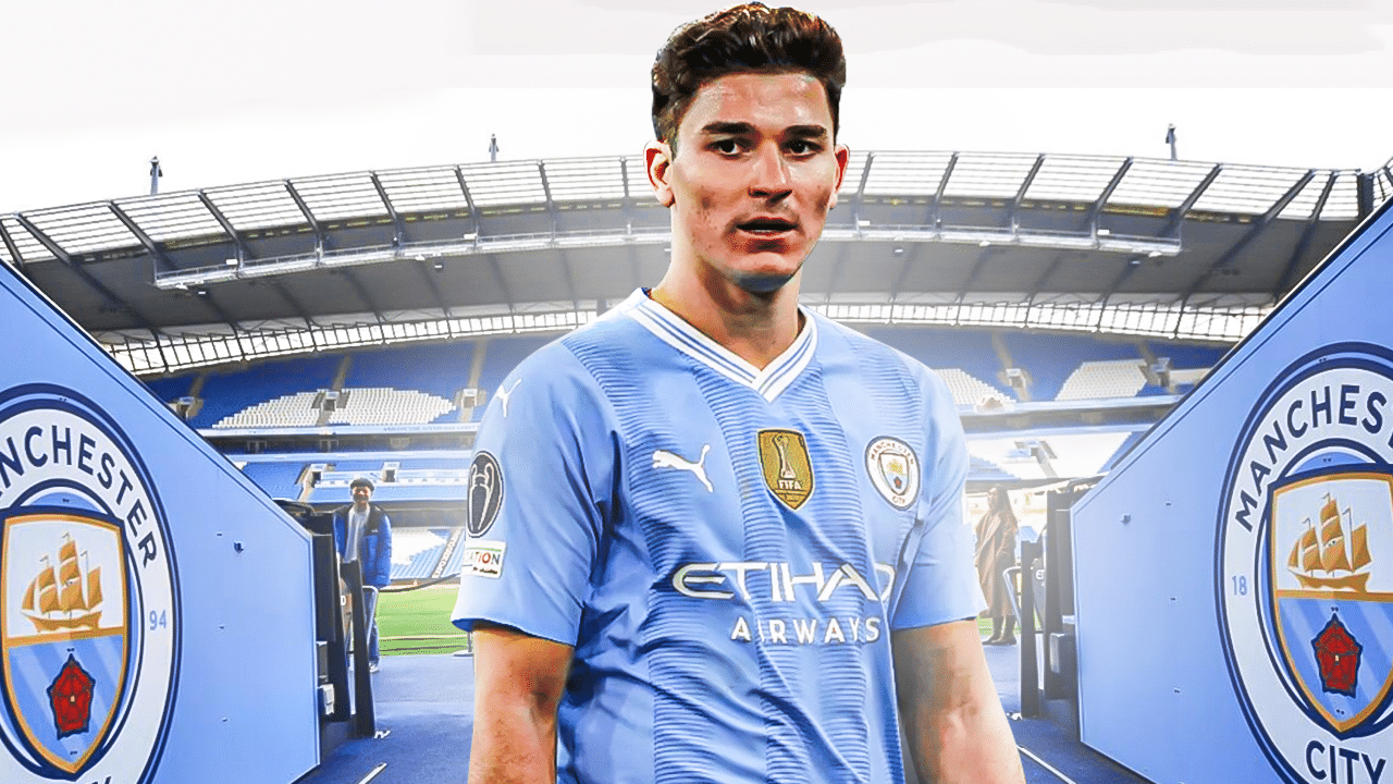 Julian Alvarez in front of the Manchester City logo and an exit door