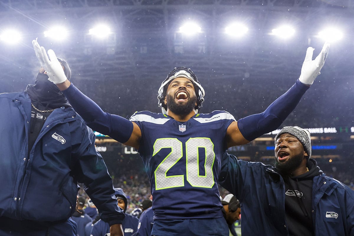 Seattle Seahawks safety Julian Love (20) celebrates on the bench after his second interception of the fourth quarter against the Philadelphia Eagles at Lumen Field. 