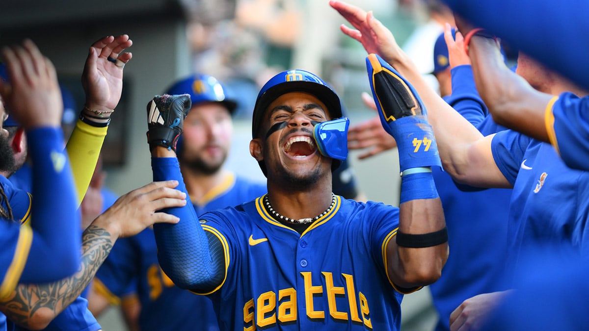 Seattle Mariners center fielder Julio Rodriguez (44) celebrates in the dugout after scoring a run against the Toronto Blue Jays during the third inning at T-Mobile Park.