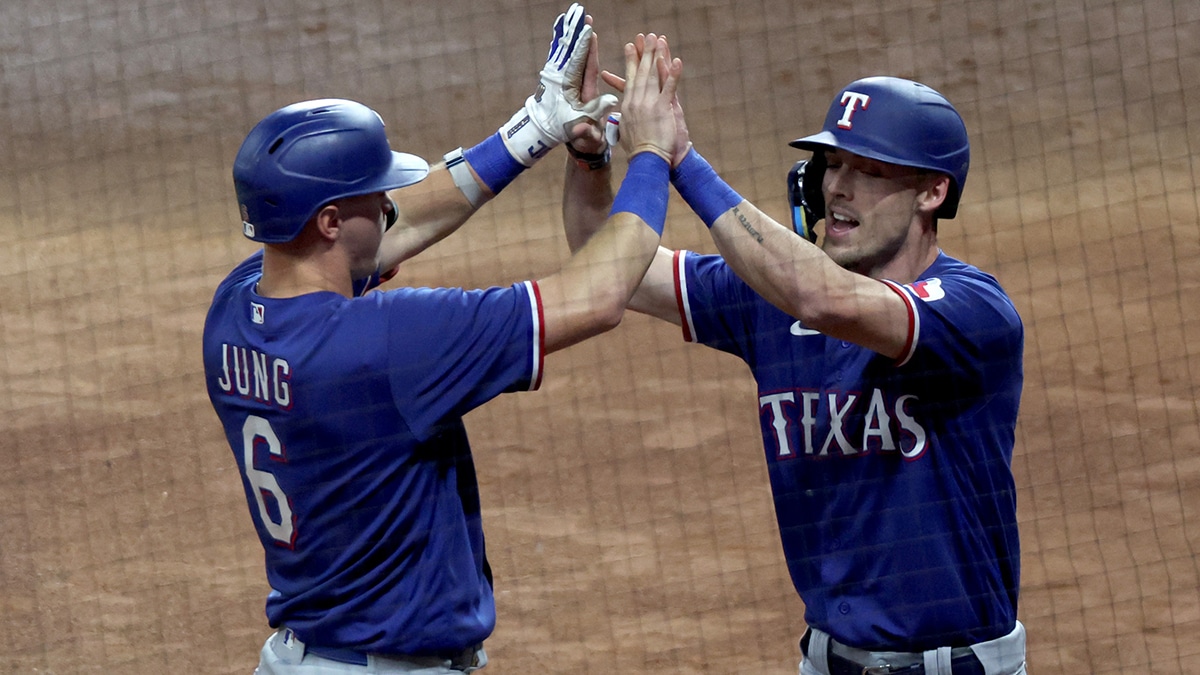 Oct 15, 2023; Houston, Texas, USA; Texas Rangers third baseman Josh Jung (6) and center fielder Evan Carter (32) celebrate after Carter scored during the first inning of game one of the ALCS against the Houston Astros in the 2023 MLB playoffs at Minute Maid Park.