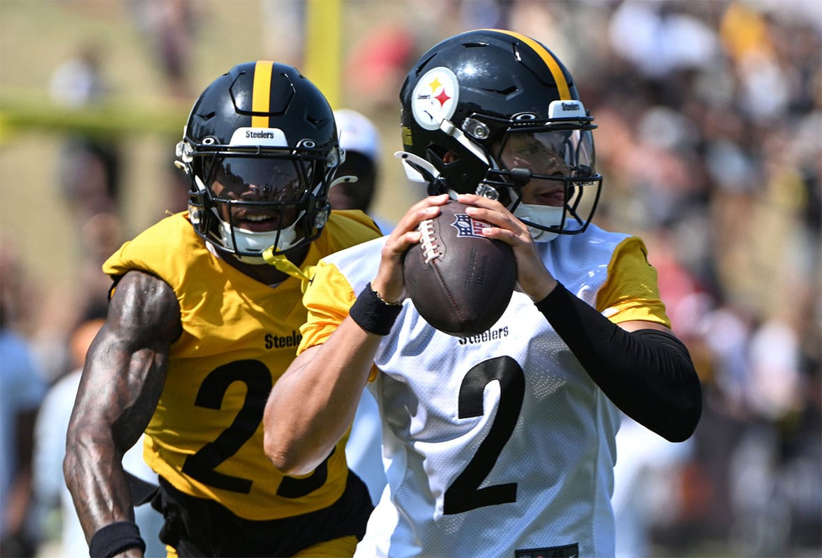 Pittsburgh Steelers quarterback Justin Fields (2) is pressured by safety DeShon Elliott (25) during training camp at Saint Vincent College. 