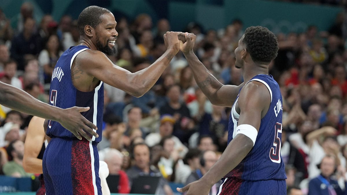 United States guard Kevin Durant (7) and guard Anthony Edwards (5) celebrate after a play in the third quarter against Serbia during the Paris 2024 Olympic Summer Games at Stade Pierre-Mauroy.
