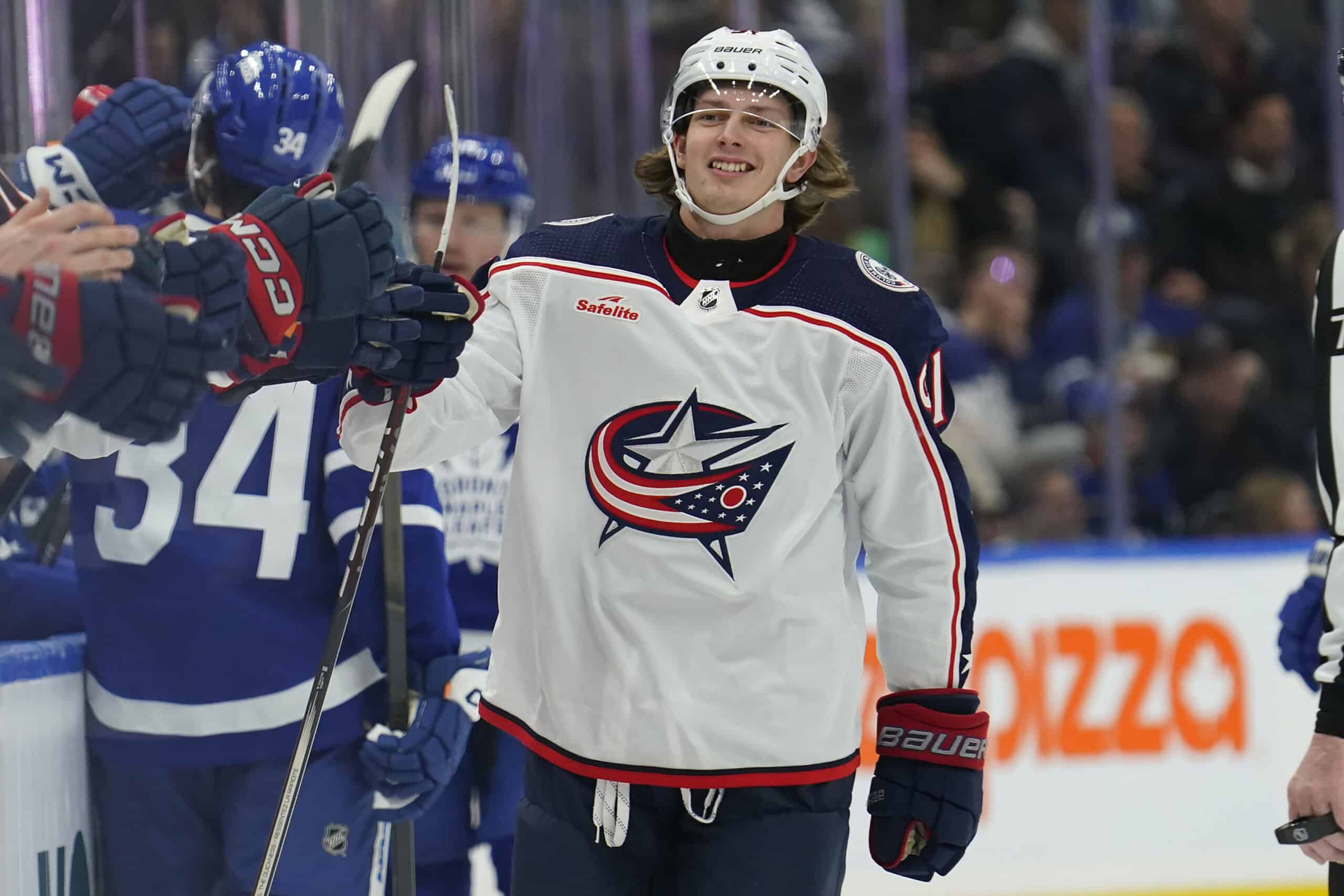 Columbus Blue Jackets forward Kent Johnson (91) gets congratulated after scoring against the Toronto Maple Leafs during the first period at Scotiabank Arena.