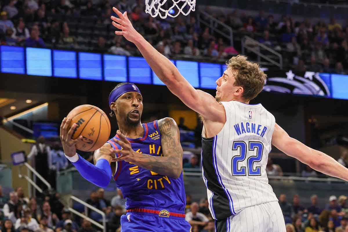Denver Nuggets guard Kentavious Caldwell-Pope (5) passes the ball around Orlando Magic forward Franz Wagner (22) during the second quarter at Amway Center.