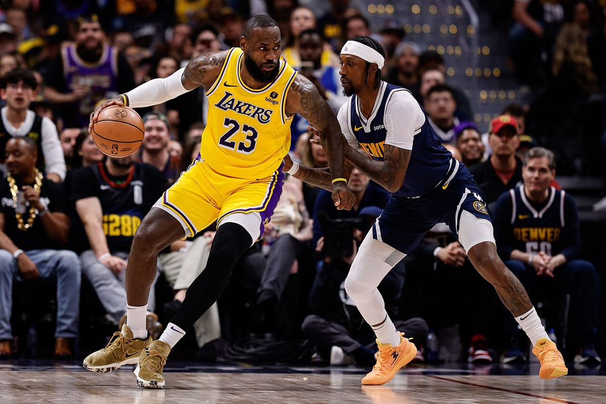 Los Angeles Lakers forward LeBron James (23) controls the ball as Denver Nuggets guard Kentavious Caldwell-Pope (5) guards in the third quarter during game five of the first round for the 2024 NBA playoffs at Ball Arena. 