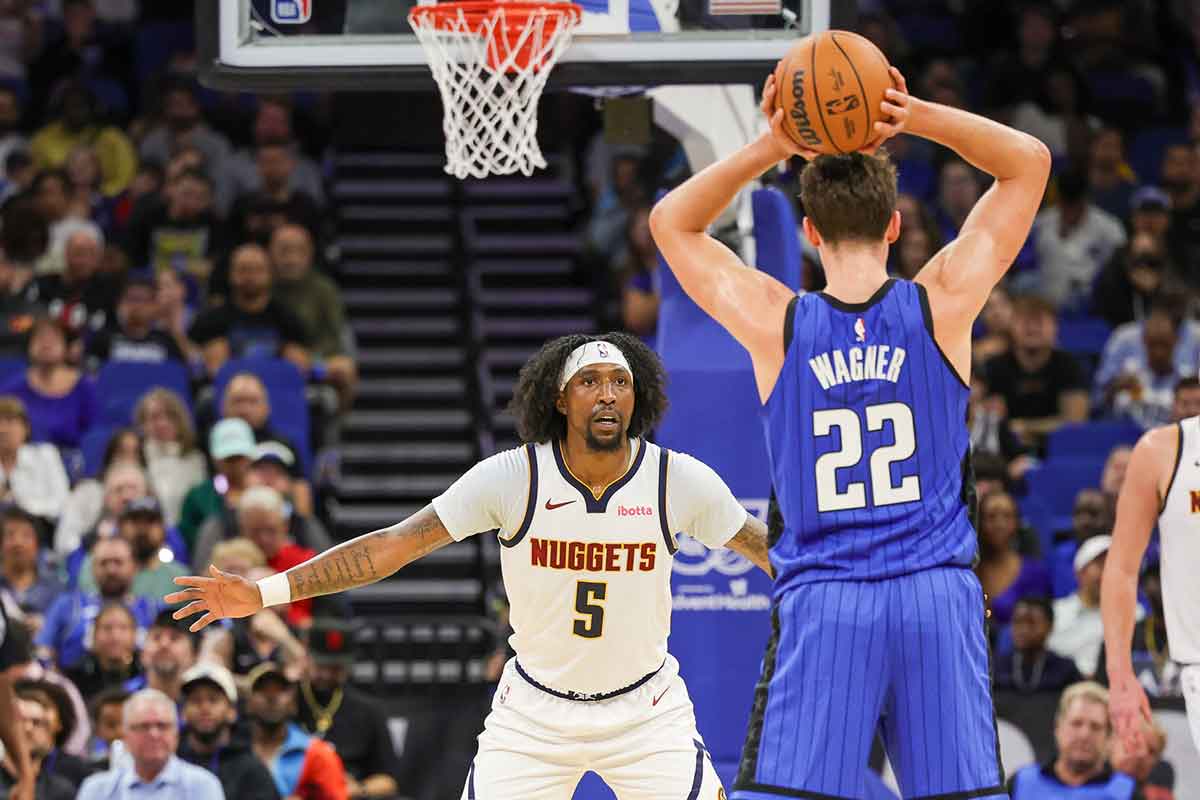 Denver Nuggets guard Kentavious Caldwell-Pope (5) defends Orlando Magic forward Franz Wagner (22) during the second quarter at Amway Center.