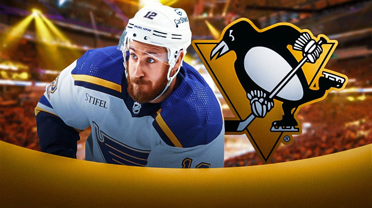 Kevin Hayes in middle looking determined, Pittsburgh Penguins logo, hockey rink in background