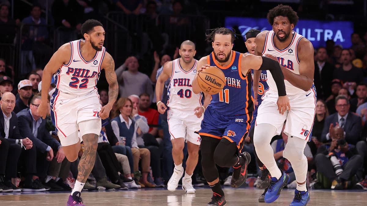 New York Knicks guard Jalen Brunson (11) brings the ball up court against Philadelphia 76ers guard Cameron Payne (22) and forward Nicolas Batum (40) and center Joel Embiid (21) after a turnover by Embiid during the fourth quarter of game 5 of the first round of the 2024 NBA playoffs at Madison Square Garden.