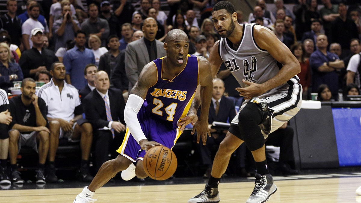 Los Angeles Lakers shooting guard Kobe Bryant (24) drives to the basket past San Antonio Spurs power forward Tim Duncan (21) during the second half at AT&T Center. The Lakers won 112-110 in overtime. 