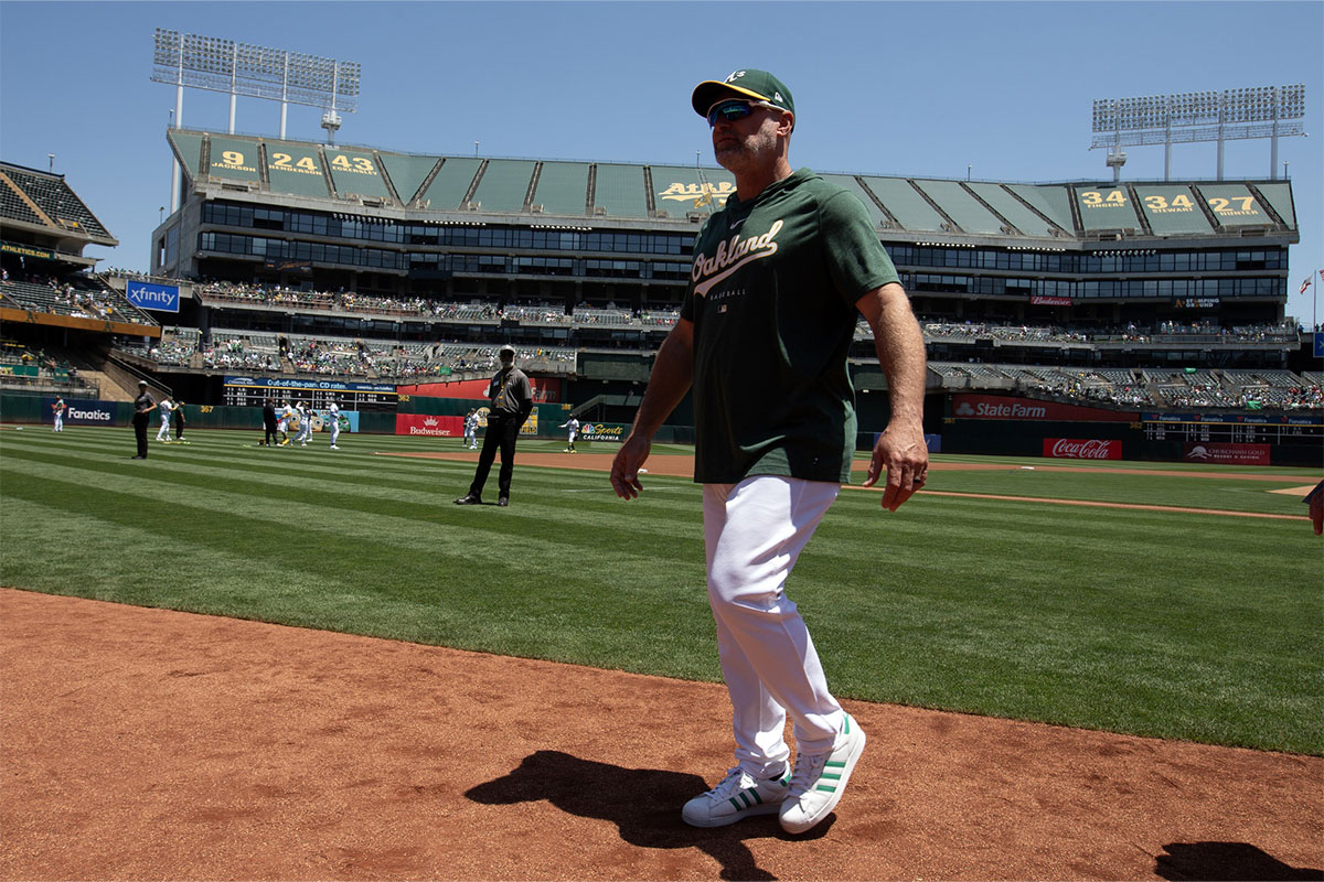  Oakland Athletics manager Mark Kotsay walks back to the dugout after the national anthem before taking on the Los Angeles Angels at Oakland-Alameda County Coliseum. 