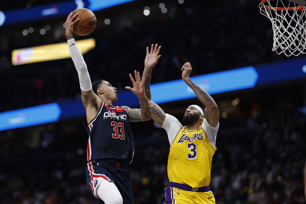 Washington Wizards forward Kyle Kuzma (33) shoots the ball as Los Angeles Lakers forward Anthony Davis (3) defends in the second half at Capital One Arena.