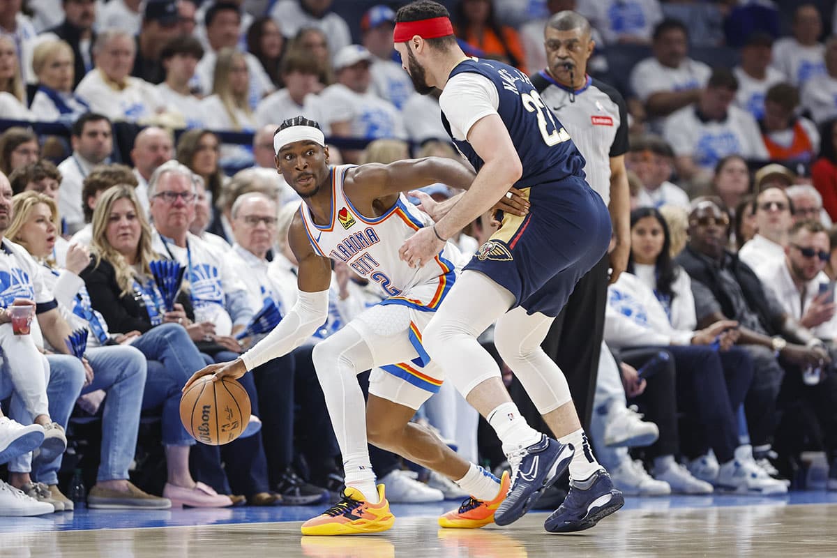 Oklahoma City Thunder guard Shai Gilgeous-Alexander (2) works his way around New Orleans Pelicans forward Larry Nance Jr. (22) during the second quarter of game one of the first round for the 2024 NBA playoffs at Paycom Center. 