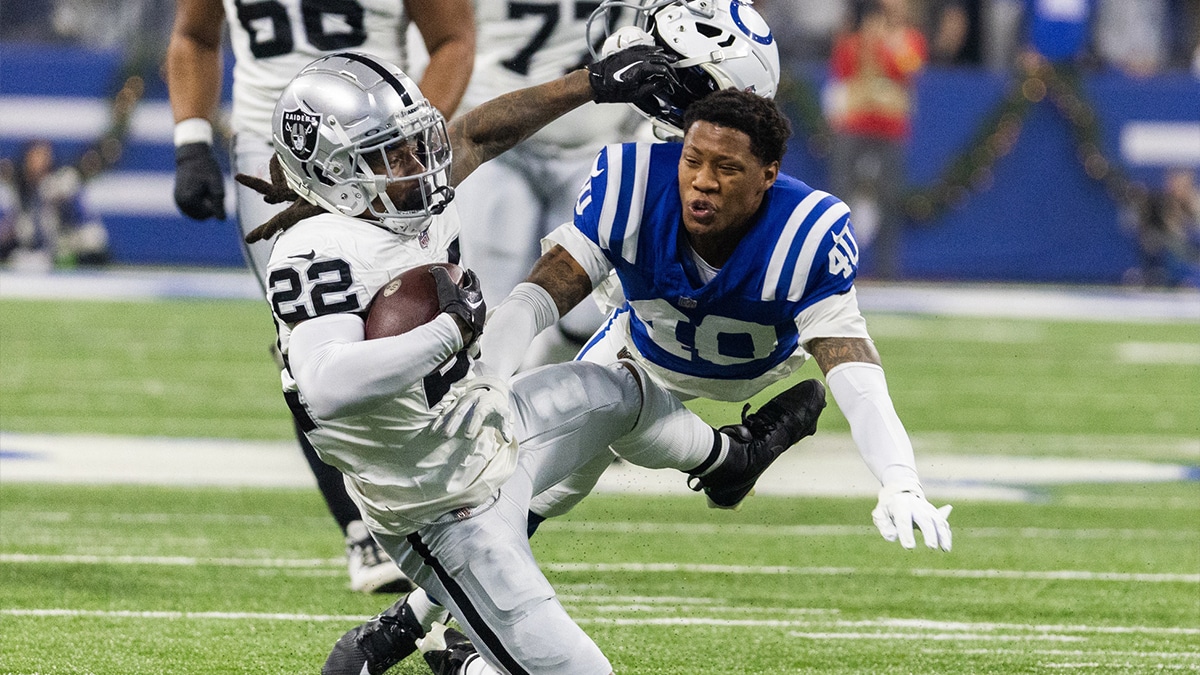 Las Vegas Raiders running back Ameer Abdullah (22) runs the ball while Indianapolis Colts cornerback Jaylon Jones (40) defends in the first quarter at Lucas Oil Stadium.