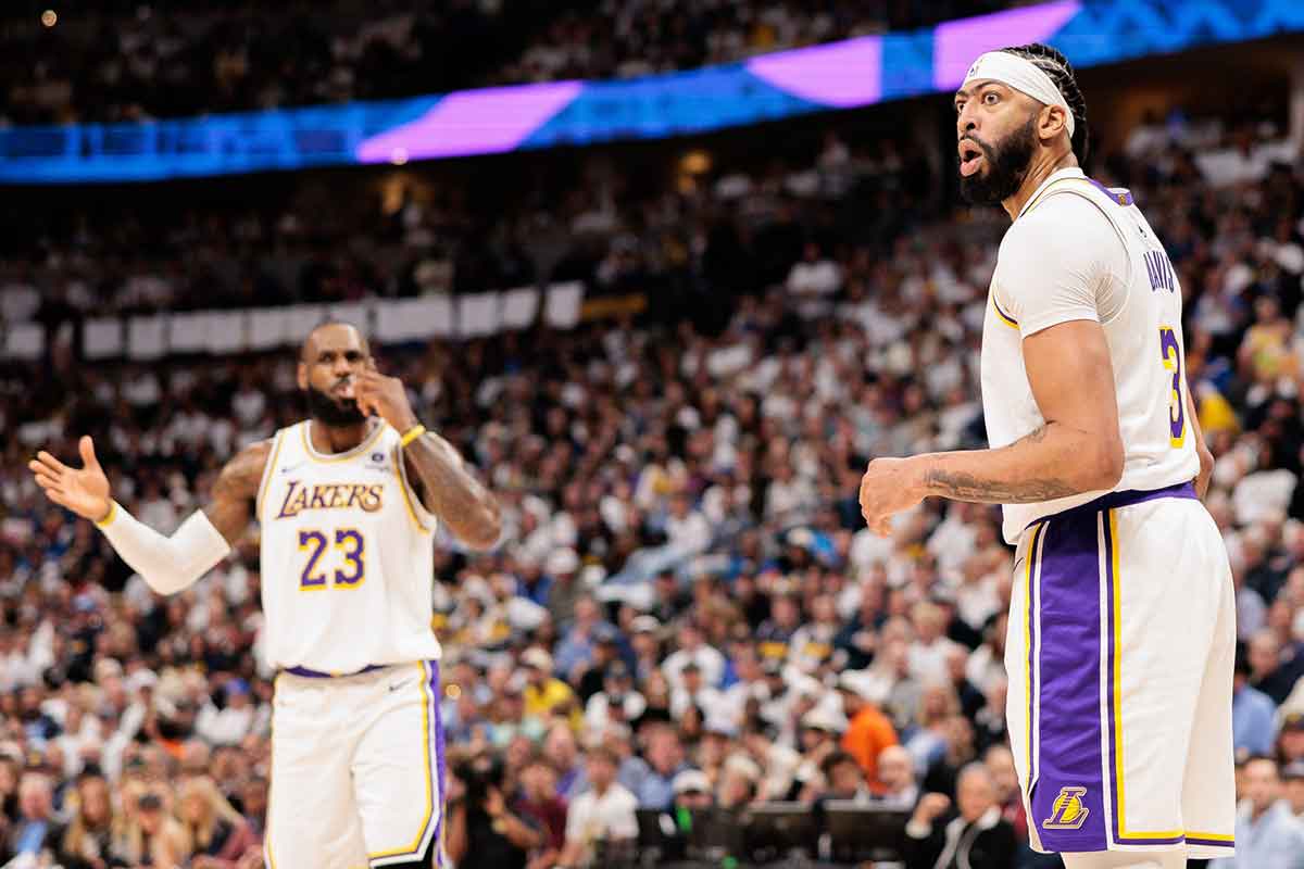 Los Angeles Lakers forward Anthony Davis (3) and forward LeBron James (23) react during the first quarter against the Denver Nuggets in game one of the first round for the 2024 NBA playoffs at Ball Arena. 