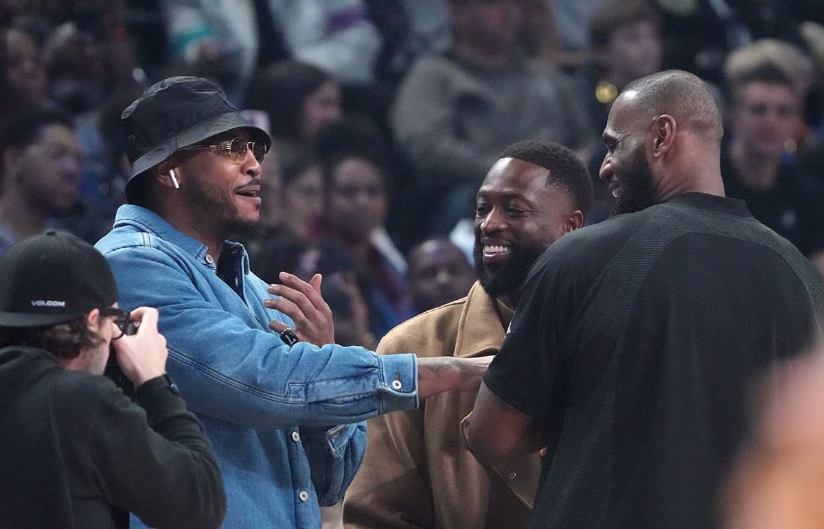 Carmelo Anthony, Dwyane Wade and LeBron James greet each other before the 2023 NBA All-Star Game at Vivint Arena.