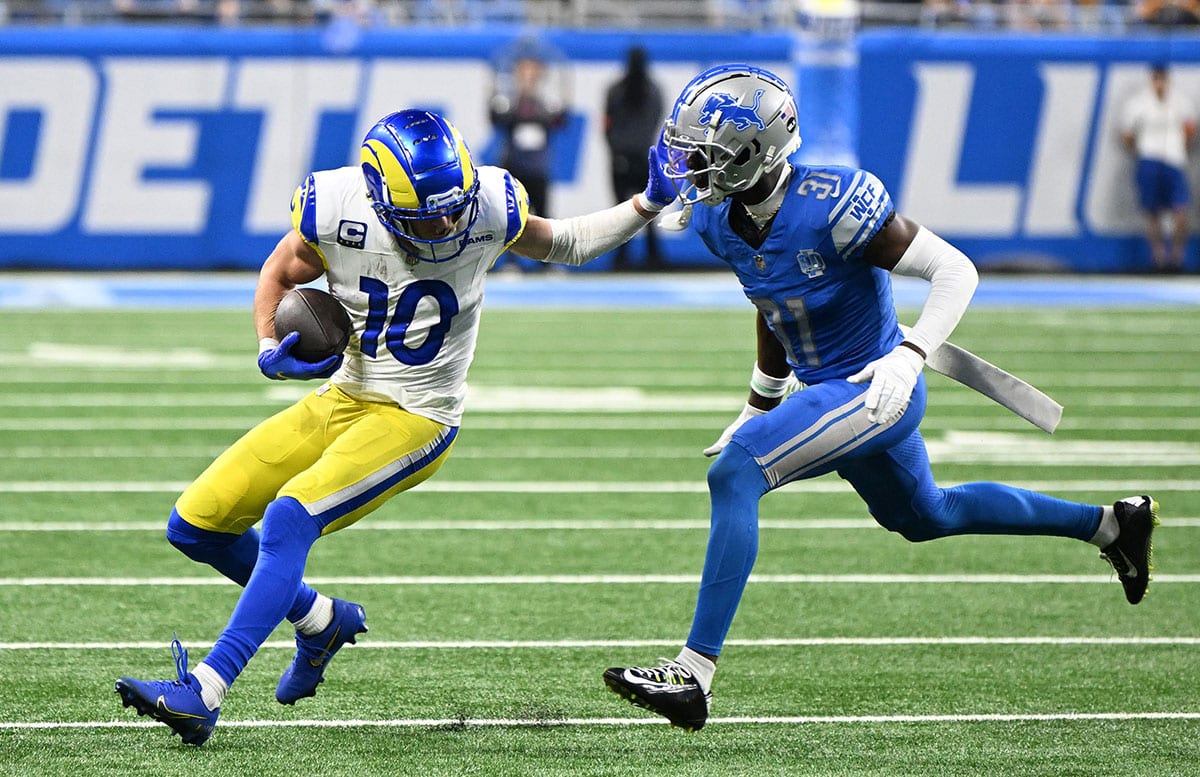 Los Angeles Rams wide receiver Cooper Kupp (10) attempts to avoid the tackle of Detroit Lions safety Kerby Joseph (31) during the second half of a 2024 NFC wild card game at Ford Field. 
