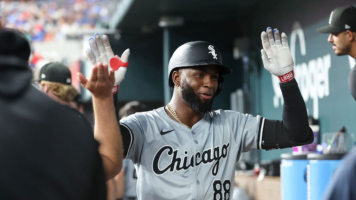 Chicago White Sox center fielder Luis Robert Jr. (88) celebrates with teammates in the dugout after hitting a home run during the third inning against the Texas Rangers at Globe Life Field.