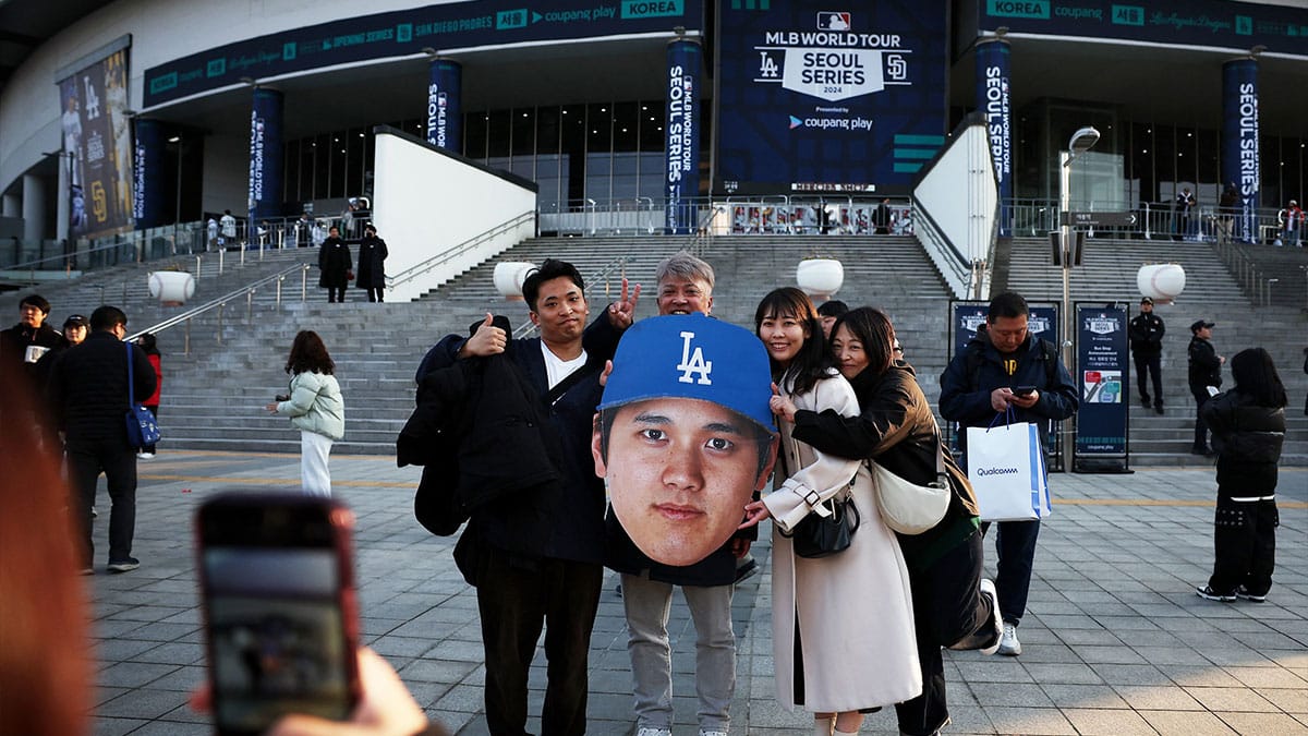 Fans pose for a picture with an image of Los Angeles Dodgers player Shohei Ohtani outside the stadium before the game against the San Diego Padres at Gocheok Sky Dome.