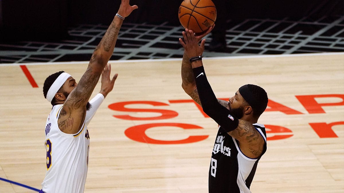 Los Angeles Clippers forward Marcus Morris Sr. (8) shoots against Los Angeles Lakers forward Markieff Morris (88) during the first half at Staples Center.