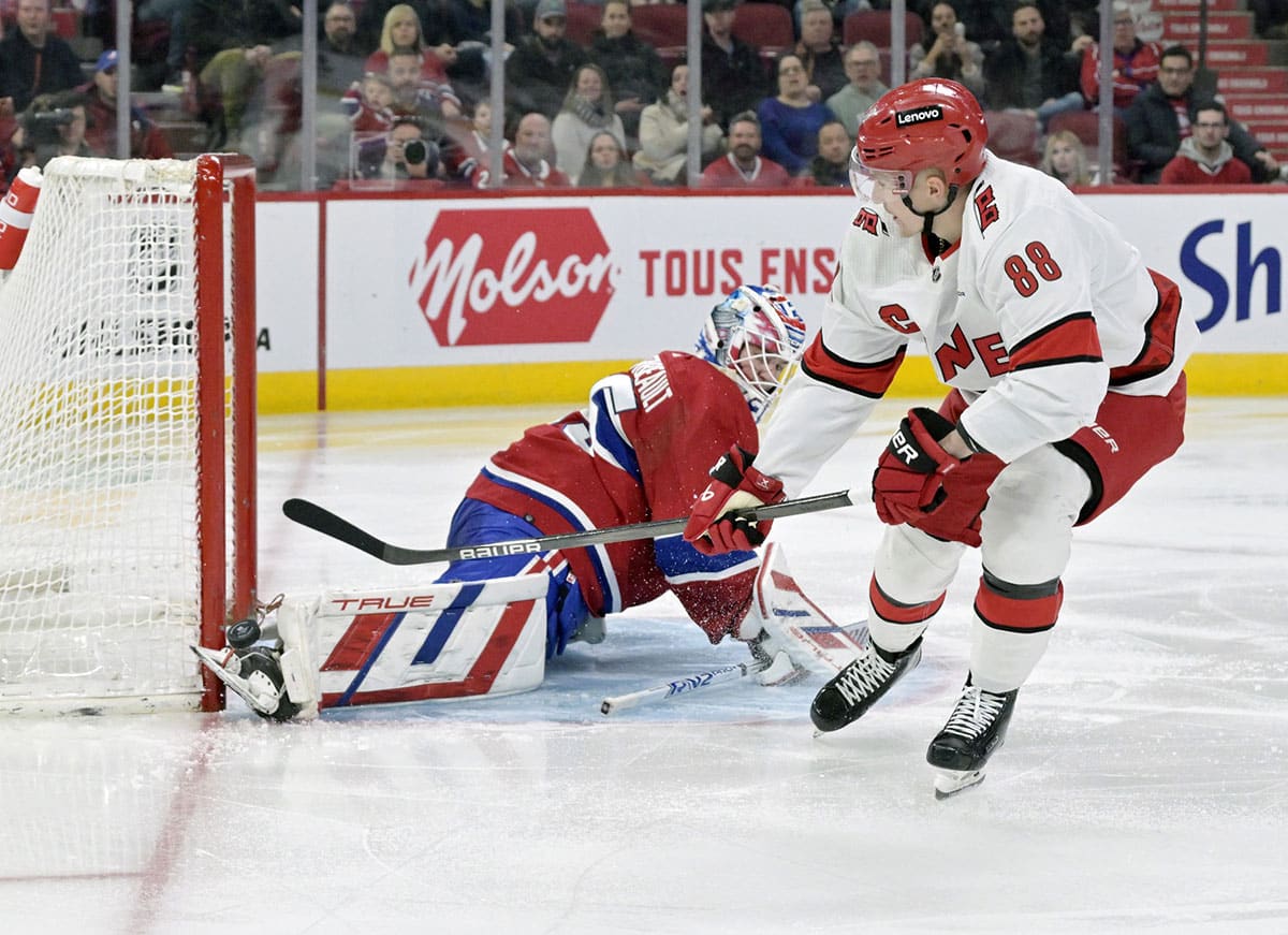 Montreal Canadiens goalie Sam Montembeault (35) makes a save with his skate against Carolina Hurricanes forward Martin Necas (88) during the third period at the Bell Centre.