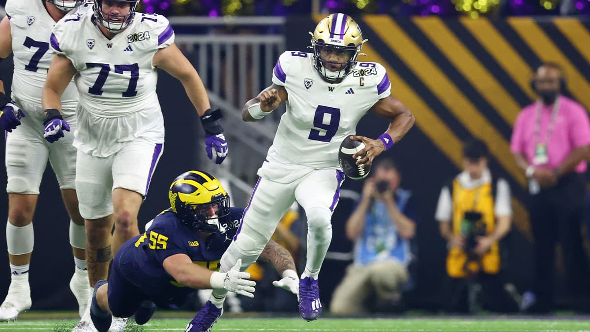 Washington Huskies quarterback Michael Penix Jr. (9) runs with the ball against Michigan Wolverines defensive lineman Mason Graham (55) during the first quarter in the 2024 College Football Playoff national championship game at NRG Stadium.