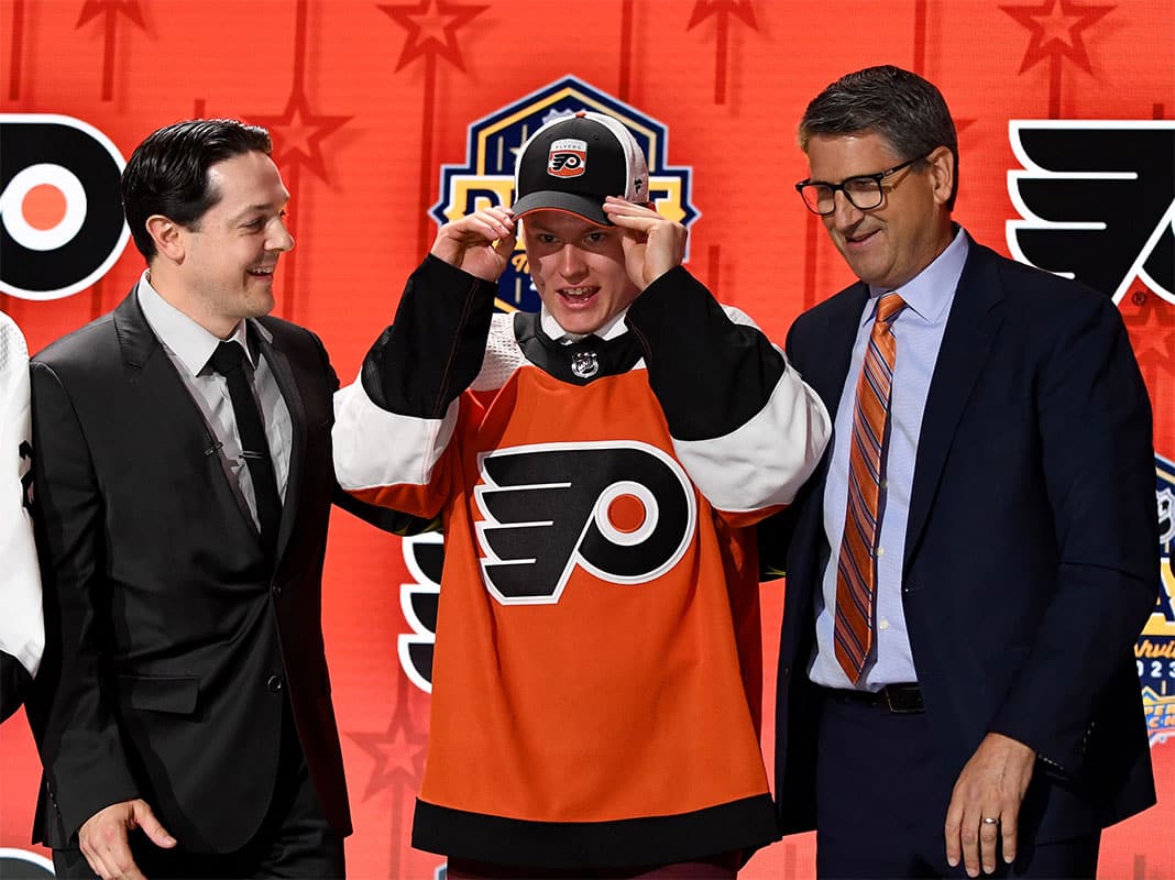 Philadelphia Flyers draft pick Matvei Michkov puts on his hat after being selected with the seventh pick in round one of the 2023 NHL Draft at Bridgestone Arena.