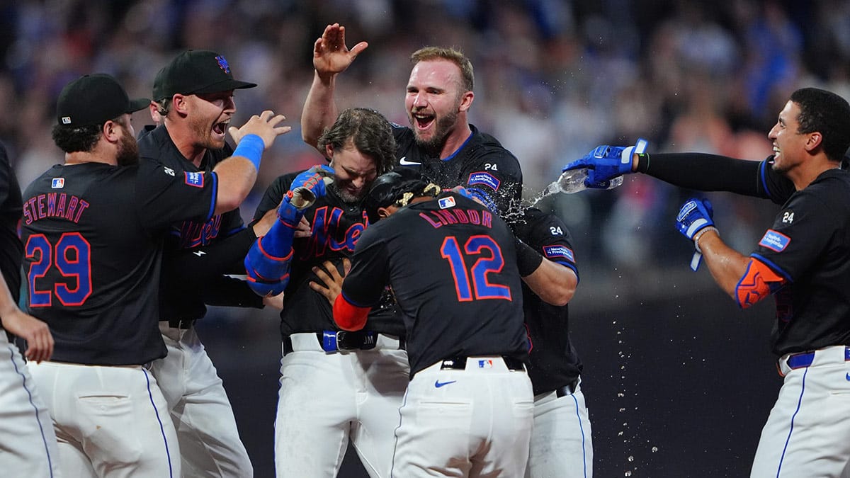 New York Mets left fielder Jeff McNeil (1) is congratulated by teammates for getting the game winning hit against the Atlanta Braves during the tenth inning at Citi Field. 