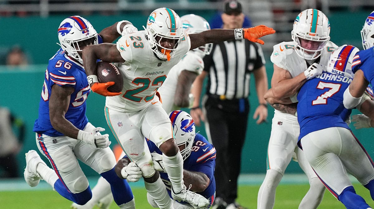 Miami Dolphins running back Jeff Wilson Jr. (23), leaps through a tackle against the Buffalo Bills.