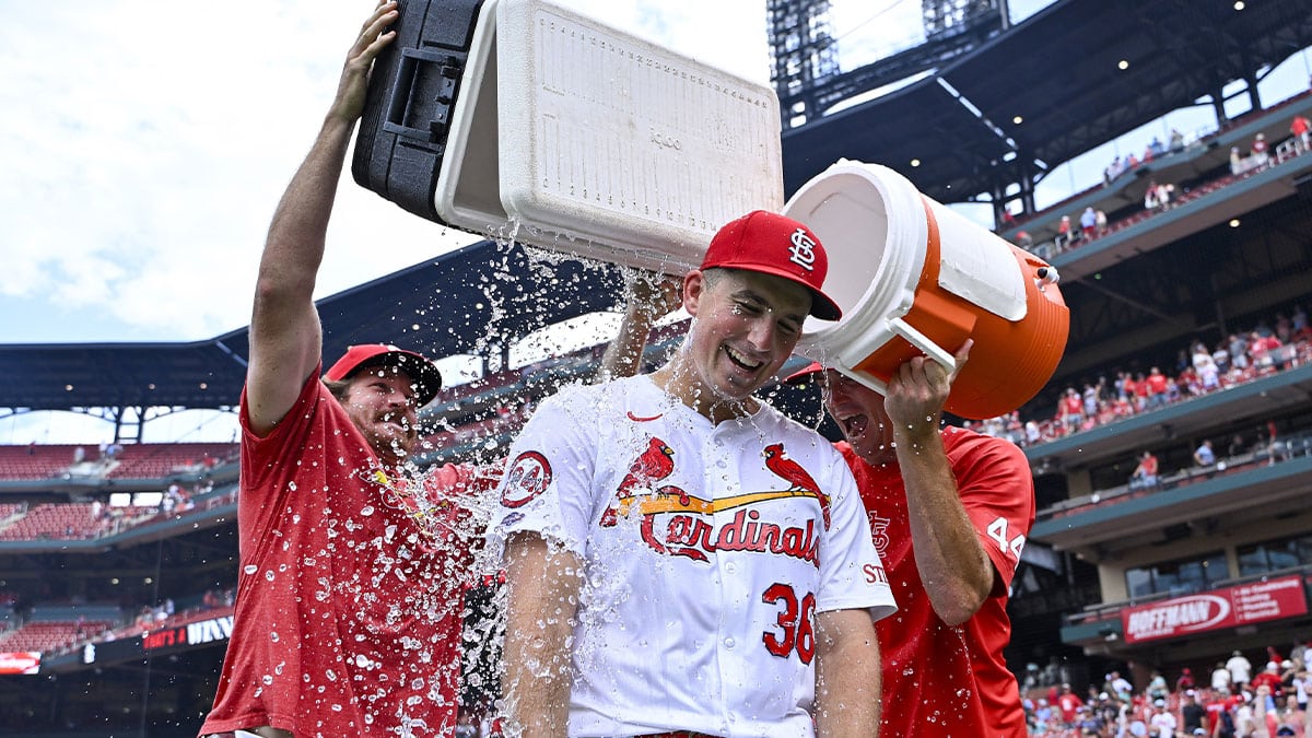 St. Louis Cardinals starting pitcher Michael McGreevy (36) is doused with water by pitcher Miles Mikolas (left) and pitcher Kyle Gibson (right) after winning his first MLB game in his Major League Debut against the Texas Rangers at Busch Stadium.