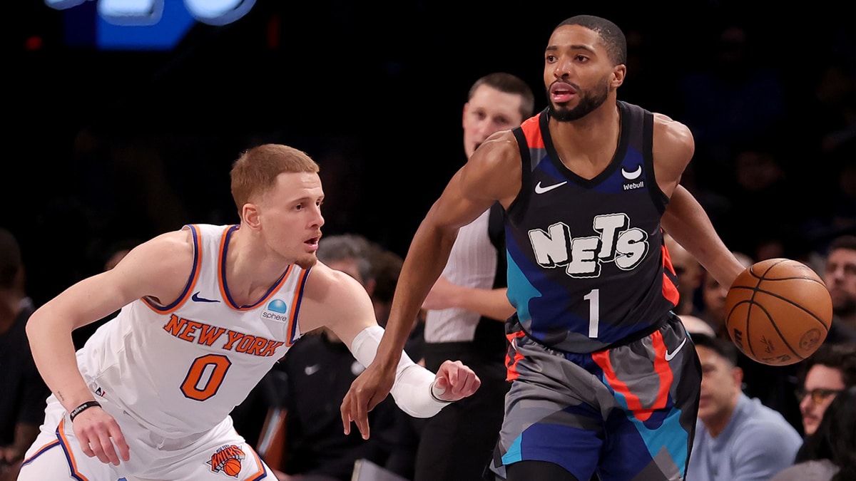 Brooklyn Nets forward Mikal Bridges (1) controls the ball against New York Knicks guard Donte DiVincenzo (0) during the first quarter at Barclays Center. 