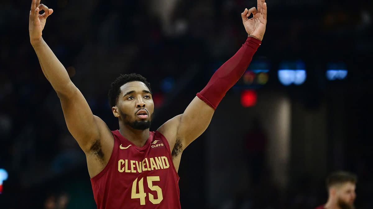 Cleveland Cavaliers guard Donovan Mitchell (45) celebrates after forward Dean Wade (32) hit a three point basket during the first half against the Atlanta Hawks at Rocket Mortgage FieldHouse.
