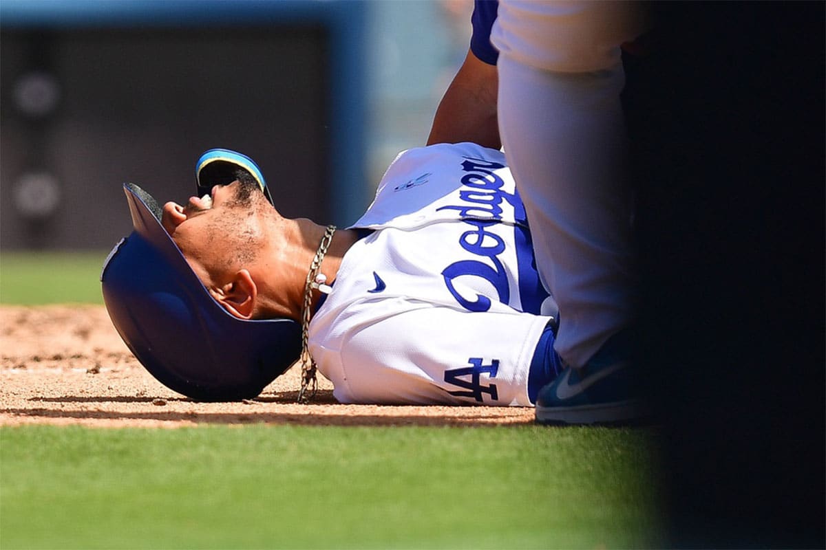 Los Angeles Dodgers shortstop Mookie Betts (50) reacts after being hit by pitch from Kansas City Royals pitcher Dan Altavilla (54) during the seventh inning at Dodger Stadium.