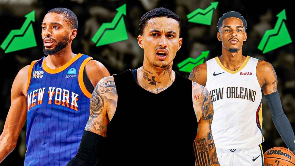 Kyle Kuzma in a blank uniform with the stock up logo all over him, Dejounte Murray in Pelicans uni and Mikal Bridges in Knicks uni beside Kuzma
