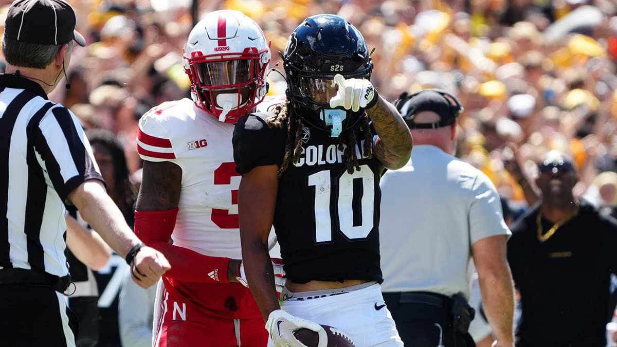 Colorado Buffaloes wide receiver Xavier Weaver (10) reacts to his first down reception catch next to Nebraska Cornhuskers linebacker Nick Henrich (3) during the third quarter at Folsom Field.