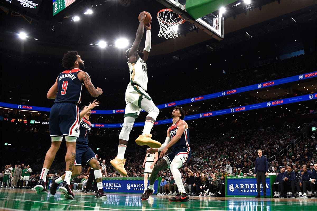 Boston Celtics center Neemias Queta (88) dunks the ball while Washington Wizards forward Justin Champagne (9) and guard Jules Bernard (14) look on during the second half at TD Garden.